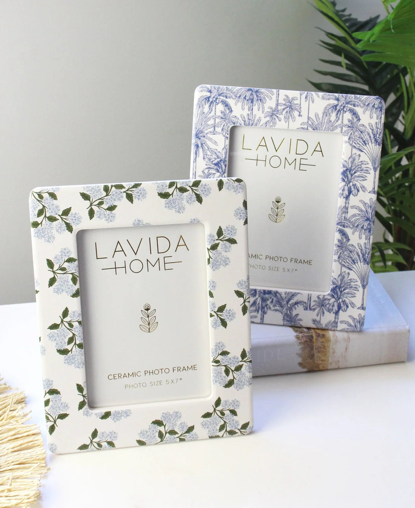 Ceramic photo frame with palm tree design in blue and white.