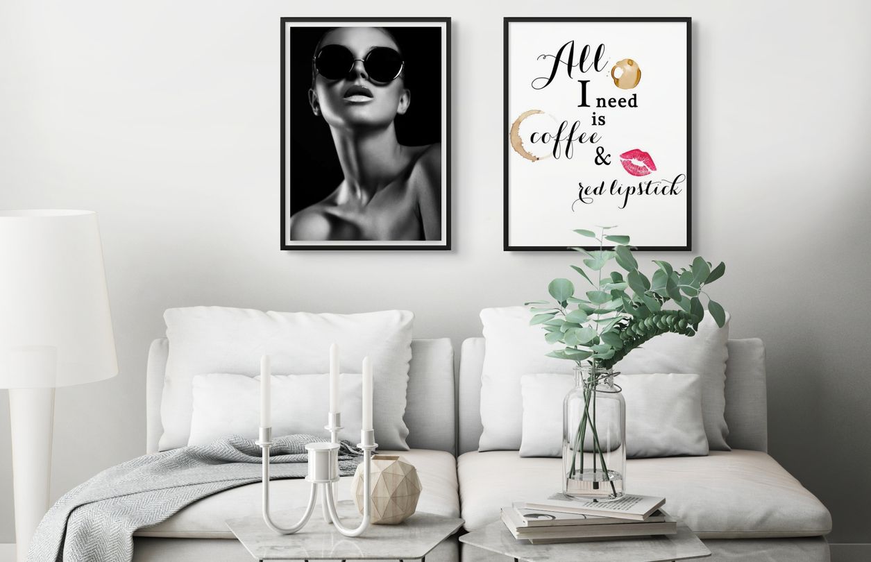 Framed black and white fashion wall art work of model wearing black sunglasses.