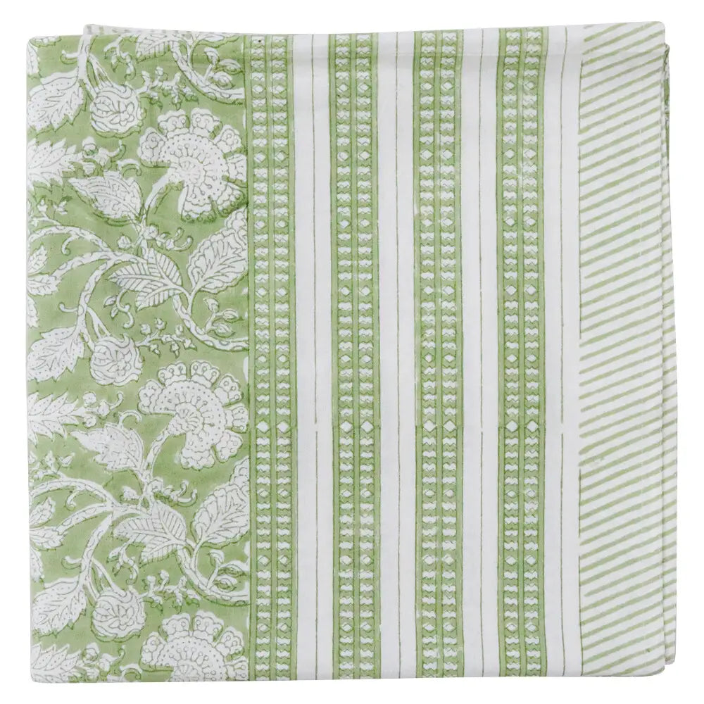 Folded Antibes green block printed cotton tablecloth showing striped and floral pattern detail