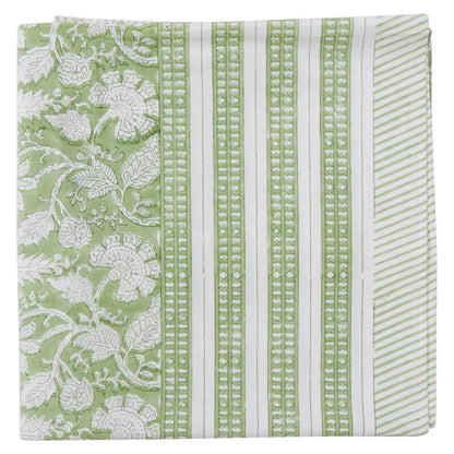 Folded Antibes green block printed cotton tablecloth showing striped and floral pattern detail