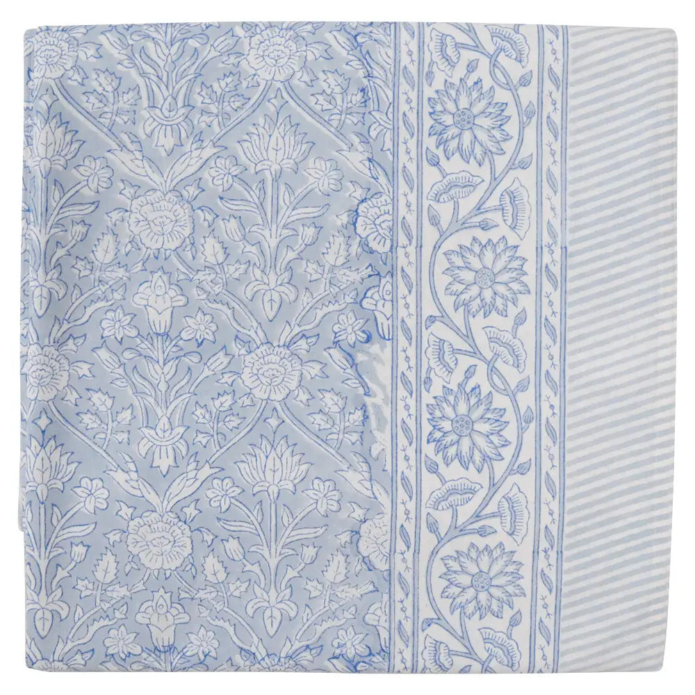 Blue floral block print cotton tablecloth with delicate hand printed pattern on white background.