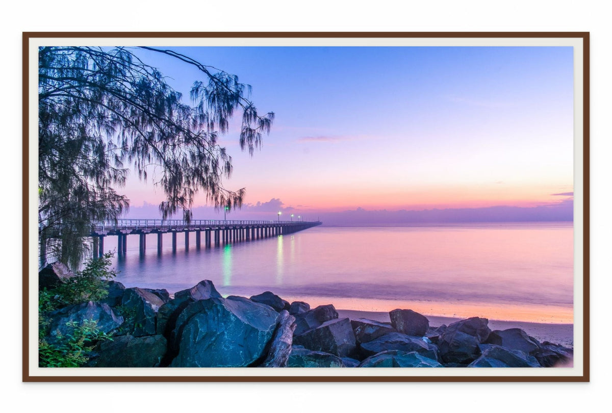 Framed wall art print of a dock at sunset with a purple and pink sky.