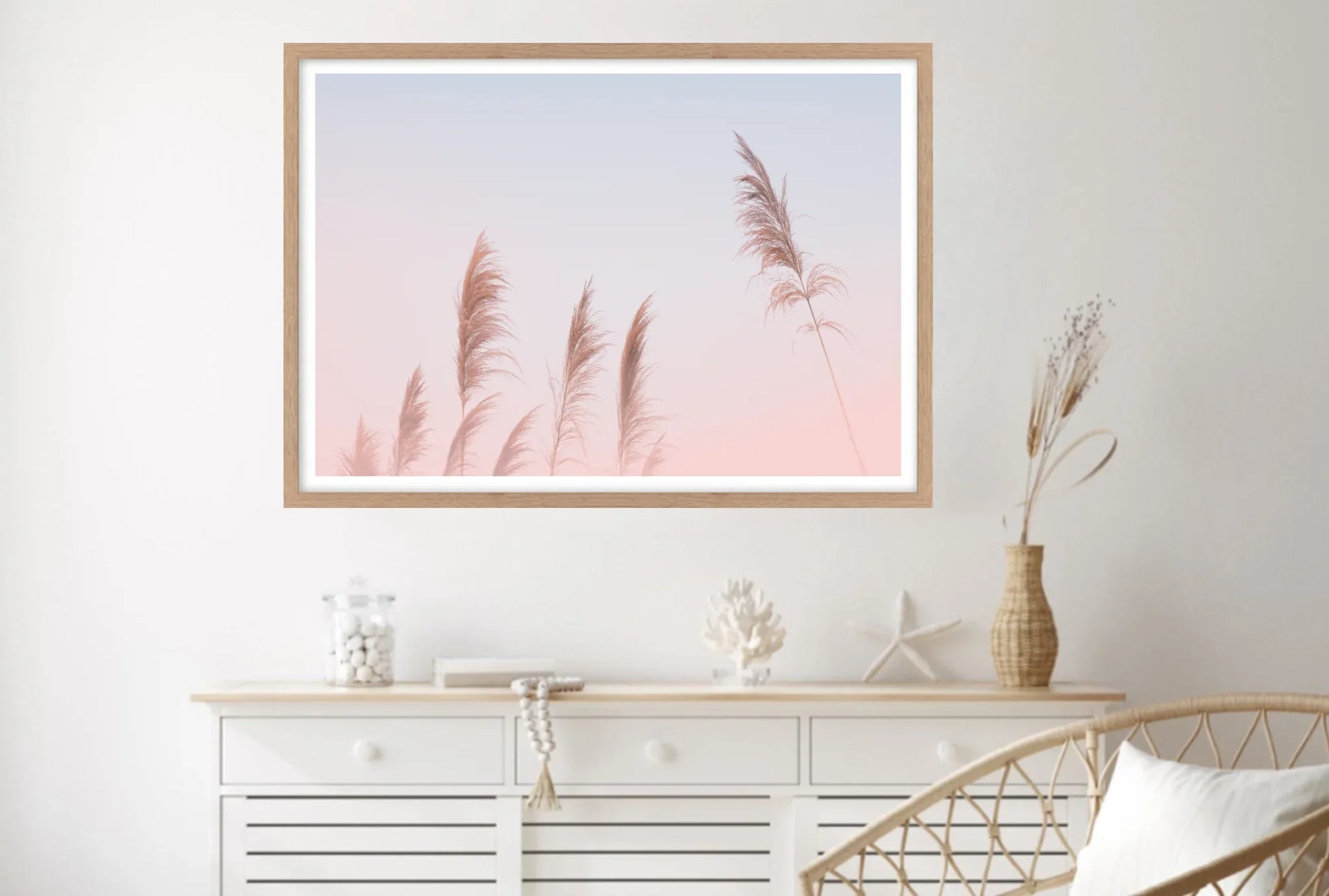 Framed artwork of pampas grasses with pink sunset background.