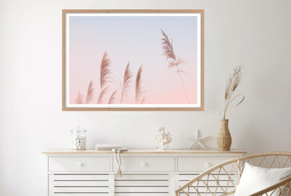 Framed artwork of pampas grasses with pink sunset background.