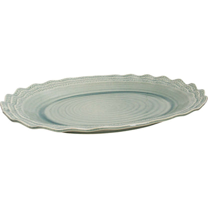 Extra large sage green ceramic oval serving platter with scalloped edge.